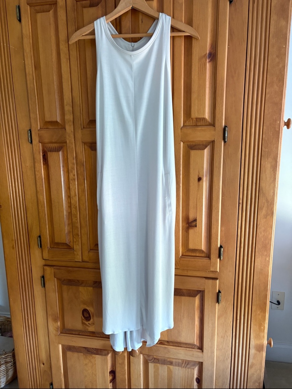 Sleeveless Racerback athletic style dress. Soft bone color w/ pockets. NWOT